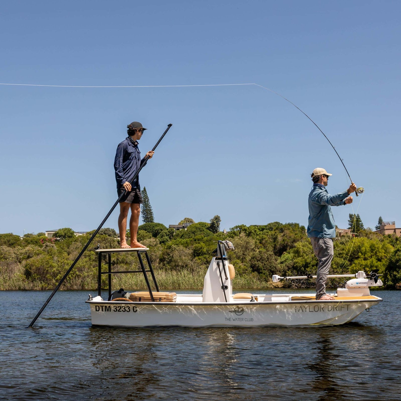 Angler and guide fly fishing from a skiff on the Touw River, Wilderness
