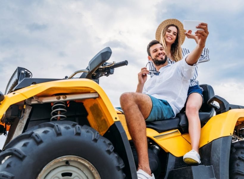 happy-young-couple-sitting-on-atv-and-taking-selfie-e1645648008790.jpg